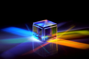 a crystal cube reflects colored rays