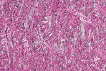 Pink  abstract background with wooden texture. Painted OSB panel. detailed view of wood chip particle board building construction material in vivid pink colour.