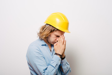 Construction worker praying