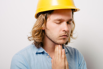 Construction worker praying