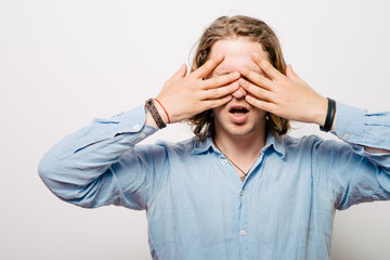 Fototapeta premium Man closes eyes with her hands