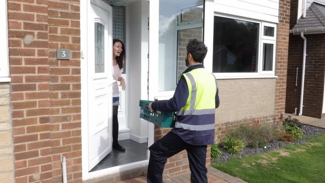 Online Grocery shopping delivery - The driver from Supermarket delivers crate of food to customer at home