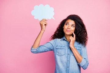 Portrait of positive inspired curious afro american girl hold white paper card speech bubble think thoughts about weekends wear stylish outfit isolated over pink color background