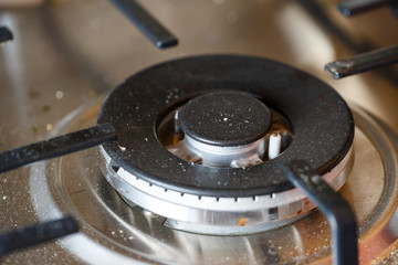 dirty steel gas surface for cooking after use by the cook