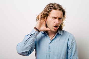 Overhears a man, tries to listen.