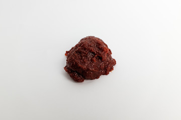 Red and spicy red pepper paste on white background