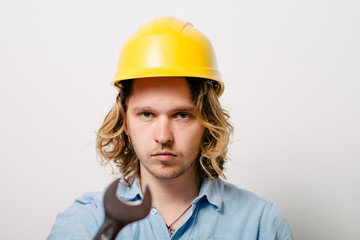 Portrait of young handyman holding a wrench