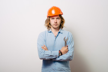 Portrait of young handyman holding a wrench