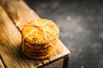 Fresh and healthy cookies with chocolate and seeds on the rustic background. Selective focus. Shallow depth of field.