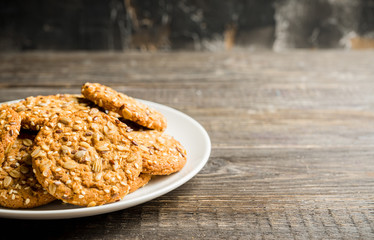 Fresh and healthy cookies with chocolate and seeds on the rustic background. Selective focus. Shallow depth of field.
