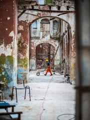 Construction worker pushing a wheelbarrow in an old house