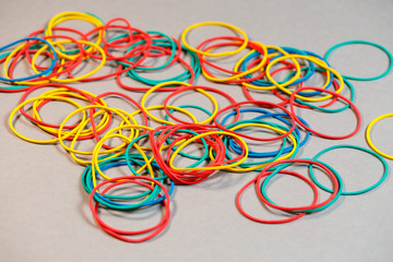Colored rubber bands for money on a colored background. Stationery accessories