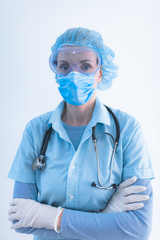 Medical doctor, nurse, surgeon, psychologist working with protective mask, glasses and gloves helping people in the days of panic, pandemic.