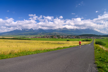 Athlete train under mountains, Beautiful mountains landscape in background