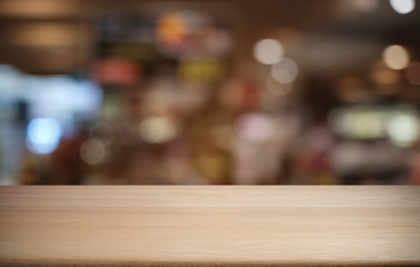 Empty dark wooden table in front of abstract blurred bokeh background of restaurant . can be used for display or montage your products.Mock up for space.