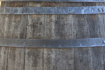 A close up photograph of the side of a barrel.  Old wood and metalwork texture, industrial concept.