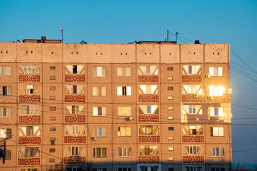 Sunset in the city, view of the tall buildings from the window during sunset.