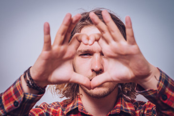 man making a hand heart frame