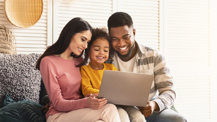 Communication on skype. International family with laptop