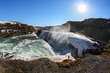 Fast and deep large waterfall in snow, in winter Iceland