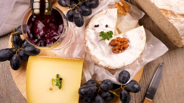 selection of French cheese, grape, bread and red wine