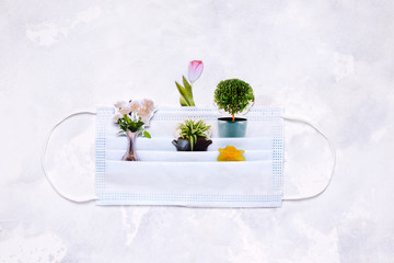 collage with a medical mask and flowers on a white background. concept of spring and summer during...