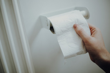 Woman grabbing toilet paper