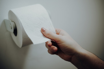 Woman grabbing toilet paper