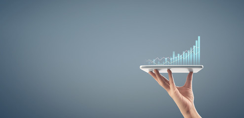  Graph growth and increase of chart positive indicators in his business,tablet in hand