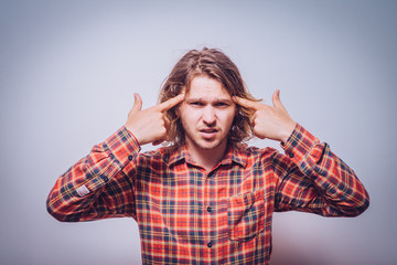 Closeup portrait of angry man gesturing with his finger against his temple, are you crazy?