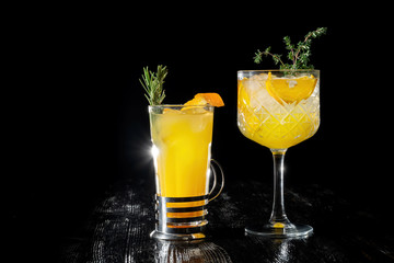 Two alcoholic cocktail with juice garnished gin, apricot brandy and orange juice.