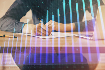 Double exposure hands with stock market chart.