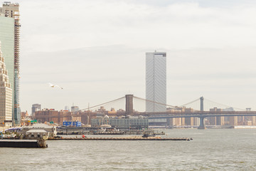 Fototapeta na wymiar View to Manhattan and Brooklyn Bridge from Ferry