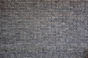 Gray textured brick wall, gray block with colored spots as background texture