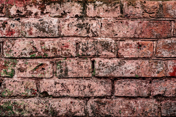 Texture of a brick wall with cracks and scratches which can be used as a background