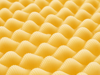 Conchiglie rigate pasta pieces. Horizontal frame. Pattern.