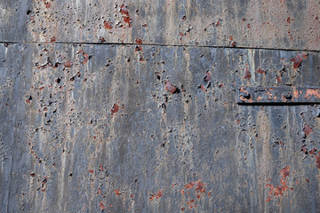 Grunge rusty metal texture. Corrosion of iron with streaks of rust. Selective focus.