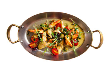 Grilled prawns shrimps with vegetables in a metal bowl, top view
