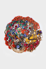 A collection of decorative jewelry, costume jewelry, and bracelets in the shape of a circle on a white background.