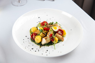 Grilled chicken with vegetables and herbs, gourmet dish, side view