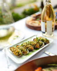 Appetizing mussels with filling, top view, white plate, white wine, gourmet, italian food