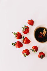 Green tea with strawberries on a white background. Flat lay, top view