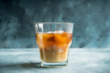 White russian cocktail with ice and cream liquor. Selective focus. Shallow depth of field.