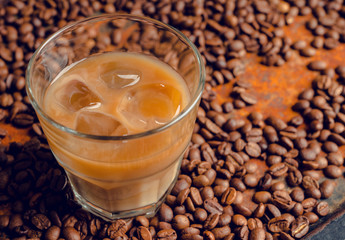 White russian cocktail with ice and cream liquor. Selective focus. Shallow depth of field.