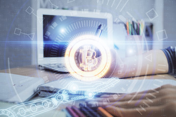 Cryptocurrency hologram, bitcoin, ico theme over hands taking notes background. Concept of blockchain. Multi exposure