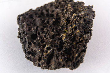Black volcanic stone with white background Macro photography