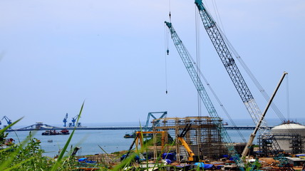 Fototapeta premium Unfocused, Blurry selective focus image the atmosphere in the steam power plant development project, Batang Indonesia
