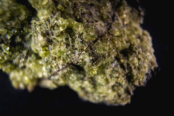 Obraz na płótnie Canvas Stone with a very beautiful green mineral with a black background. Macro photography