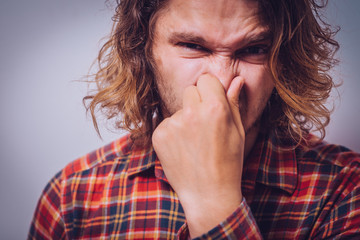 The stench. Closes the man's nose