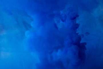 Fototapeta na wymiar Abstract flowing liquid or blue ink in water